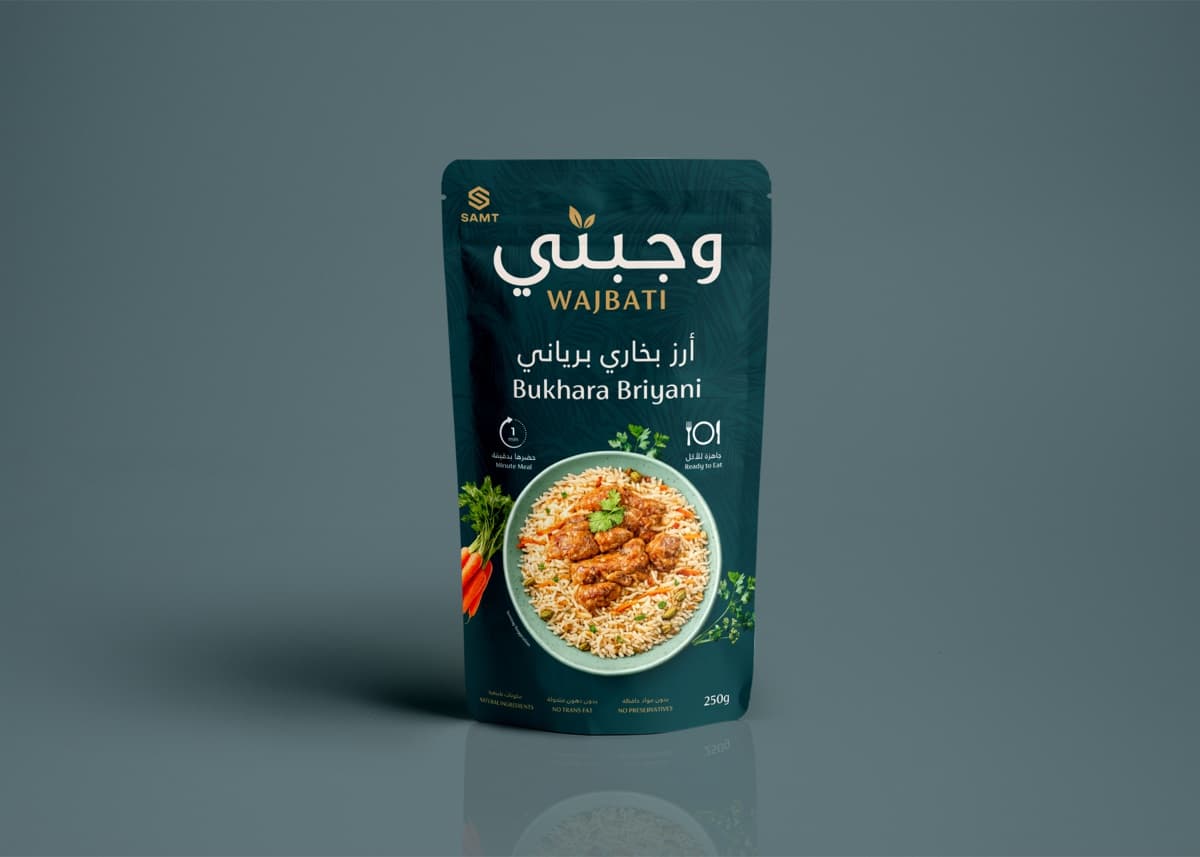 Wajbati Bukhara Briyani ambient ready-to-eat meal in a stand-up pouch, with a plated serving suggestion of chicken and rice.